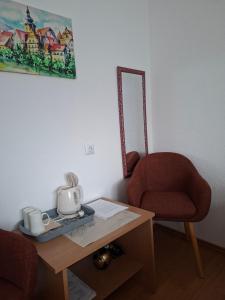 a room with a chair and a table with a mirror at Guest House Olbina in Korenica +41 photos