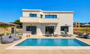 a villa with a swimming pool in front of a house at Pranvera Villa Sea View & Pool in Dhrámia +43 photos