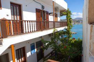 a view of the ocean from a balcony of a building at Porto Beach Apartment in Makry Gialos +29 photos