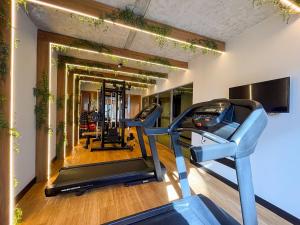 a gym with two treadmills and two ellipticals at Way Bossa in João Pessoa