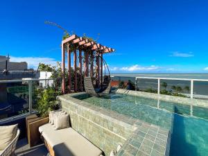 a pool on top of a building with a slide at Way Bossa in João Pessoa