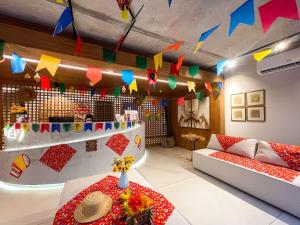 a room with two couches and a table and flags at Way Bossa in João Pessoa +47 photos