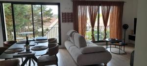 a living room with a couch and a table at Le Vivastella in Cucq
