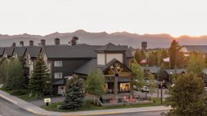 a rendering of a hotel with mountains in the background at Gray Wolf Inn & Suites in West Yellowstone