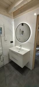 a bathroom with a white sink and a mirror at Odpoczynkowo in Orle +17 photos