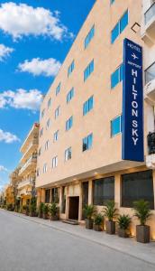 a building with a blue sign in front of it at Hotel Airport Hilton Sky IGI Delhi Airport Terminal 3 With- Free Airport Pickup in New Delhi
