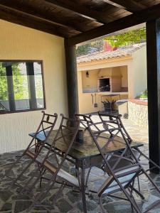 two chairs and a wooden table on a patio at Casa Rural Miravella in Castril