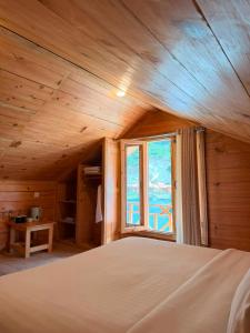 a large bed in a room with a window at Azure Lagoon Resort in Ushu +53 photos
