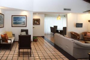 a living room with a couch and a dining room at Ocean Bloom in Cancún