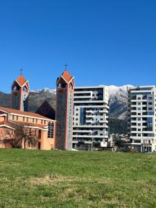 a building with two towers with mountains in the background at Doce Refugio in Bar