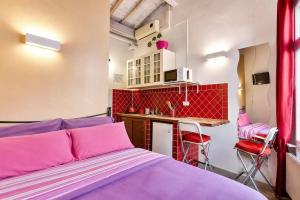 a small room with a bed and a kitchen at Max Studios Florence in Florence +44 photos