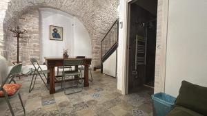a dining room with a table and a staircase at Appartamento San Giorgio in Bitonto +12 photos
