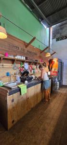 a woman standing at a counter in a kitchen at Boca Estrella in Bocas Town +51 photos