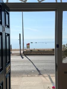 a view of the beach from a window of a building at The Angove - Adults Only in Weymouth
