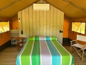 a bedroom with a bed in a tent at Vulture Glamping in Melfi