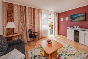 a living room with a couch and a table at Waldsiedlung Waldhaus App 4.2 in Korswandt