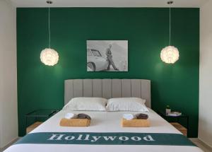 a bedroom with a large bed with two towels on it at Hollywood rooms in Sveti Petar