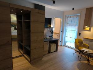 a room with a large wooden closet with a desk and a table at Landgasthaus Jägerhof in Absberg