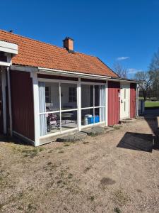a house with a large screened in porch at lillstugan in Avesta