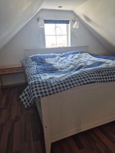 a bed in a room with a window at lillstugan in Avesta