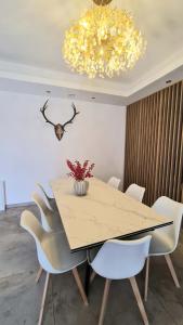a dining room with a table and white chairs at Gästehaus Ferienwohnung Wohnung #1 Jülich in Jülich