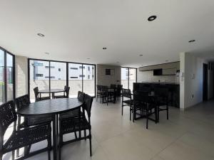 a dining room with tables and chairs and windows at Hub by Hosppedar in Cabedelo +75 photos