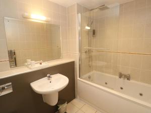 a bathroom with a sink and a toilet and a shower at Ocean Seven in Newquay +31 photos