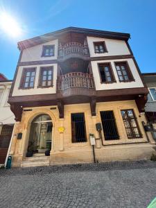 a building with a balcony on the side of it at Duru Hanım Konağı in Bursa