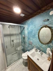 a bathroom with a shower and a sink and a mirror at Duru Hanım Konağı in Bursa +88 photos