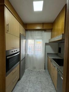 a kitchen with a refrigerator and a window in it at SotQui Cedeira in Cedeira +8 photos
