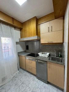 a kitchen with a sink and a stove at SotQui Cedeira in Cedeira