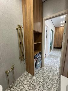 a laundry room with a washer and dryer in a bathroom at NewCityLife in Astana