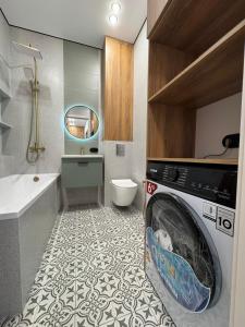 a bathroom with a washing machine in a bathroom at NewCityLife in Astana