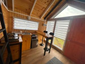 a small kitchen with a table and a window at Dyl Tiny House con Jacuzzi in Puerto Montt +8 photos