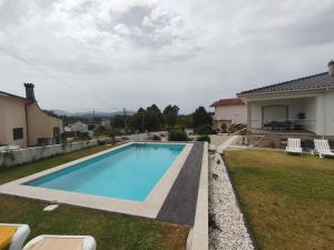 a swimming pool in the backyard of a house at Villa Beco - Moradia de Luxo com até 6 Quartos e Piscina Privada in Monção +31 photos
