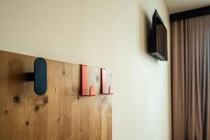 a room with a wall with a tv on a wall at easyHotel Alicante Centro in Alicante +32 photos