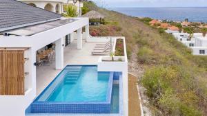 an image of a house with a swimming pool at Villa Dushi Brisa 650 - Coral Estate in Willibrordus