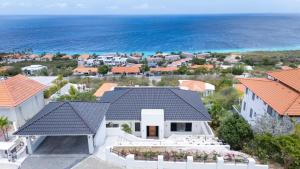 an aerial view of a house with the ocean at Villa Dushi Brisa 650 - Coral Estate in Willibrordus