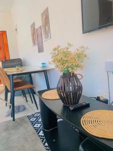 a table with a vase with flowers on it at Asanta Guest House in Ladysmith +17 photos