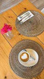 a cup of coffee sitting on a wooden table at Wawa Tarifa in Tarifa