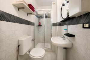 a bathroom with a toilet and a sink and a shower at Max Studios Florence in Florence