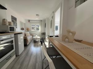 a kitchen and living room with a dining room table and a kitchen andheasternheastern at R2R - Casa Gatu - 307A in Cudillero
