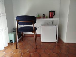 a chair sitting in a room with a counter at Camera matrimoniale Capannori, Lucca in Capannori +7 photos