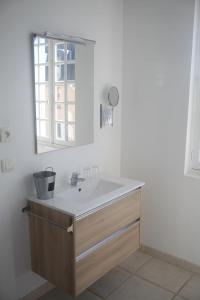 a bathroom with a sink and a mirror at hôtel du centre in Saint-Benoît-du-Sault