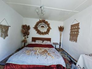 a bedroom with a large bed in a room at BOHO House in Cholpon-Ata