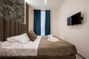 a bedroom with a bed with a flat screen tv at Guest house terra mia a Toledo in Naples +39 photos