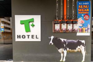 a fake cow standing in front of a hotel at T Hotel SP Pekan Lama in Sungai Petani