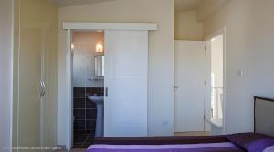 a bedroom with a sliding door to a bathroom at Villa Peri Luxury Pool Villa in Karşıyaka in Nicosia +17 photos