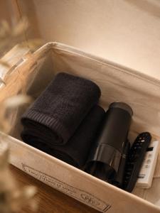 a plastic container with two towels and a remote control at Stay PAUSE in Bucheon