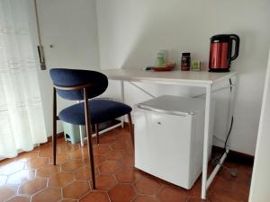 a kitchen with a desk and a chair next to a counter at Camera matrimoniale Capannori, Lucca in Capannori